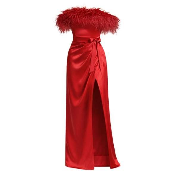 Elegant red satin gown with a feathered off-the-shoulder neckline and side slit, exudes glamour and sophistication with a tied waist accent.